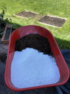 Put soil components in wheelbarrow to mix.