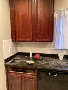 Lightly sanding existing cabinets before painting